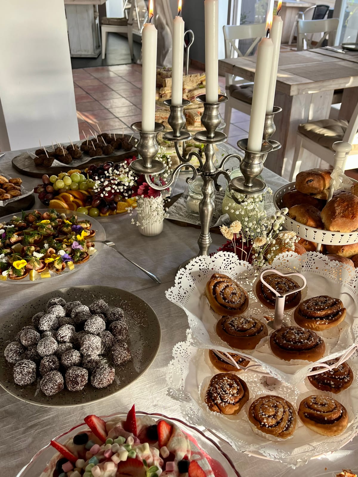 A Swedish fika spread at Julia Gastro House, Benavista — cinnamon buns, chokladbollar, Swedish meatballs and gravlax canapés